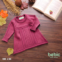 Bebic Cozy Cable Dress displayed on a model, featuring a warm, textured knit fabric in a stylish, comfortable design.