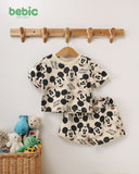 Bebic Classic Mickey Sand Set for children, featuring a colorful Mickey Mouse-themed clothing outfit displayed on a hanger.