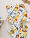 Bebic Winnie Honey Summer Set clothing with a playful yellow and white pattern, perfect for warm weather casual wear.