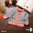 Bebic Zigzag Kitty Pocket Cardigan, cozy clothing with colorful zigzag pattern and front pocket, displayed on a hanger.